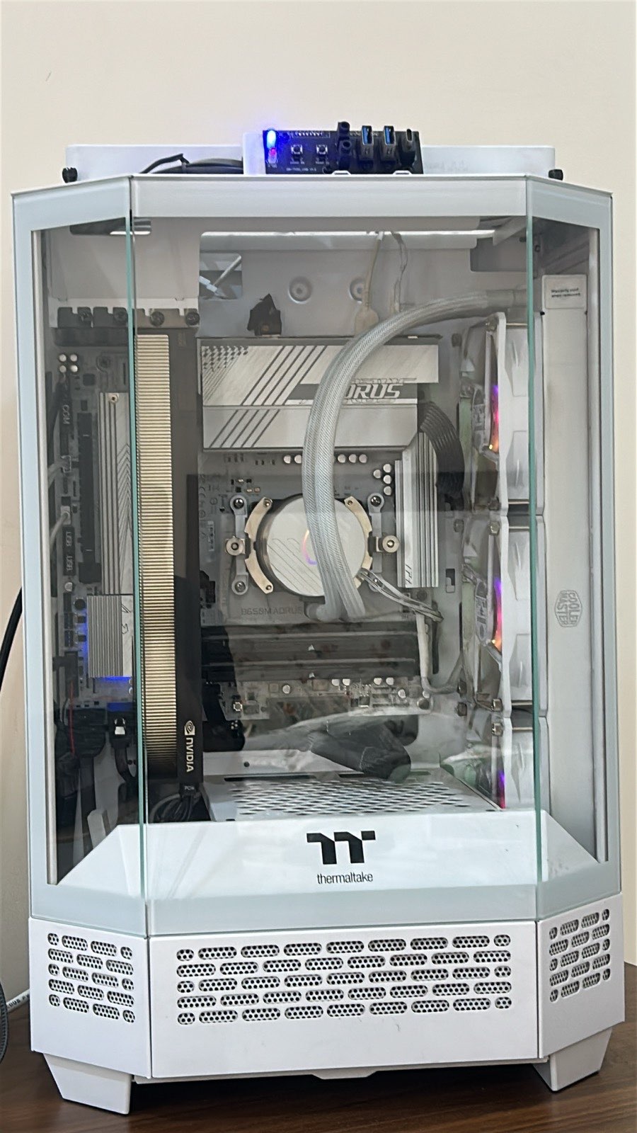White Thermaltake glass-panel workstation with a vertically mounted GPU, AORUS motherboard, and liquid CPU cooling